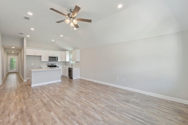 kitchen featuring visible vents, light wood finished floors, stainless steel appliances, light countertops, and open floor plan