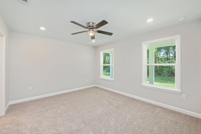 empty room with a ceiling fan, carpet, and baseboards