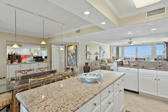 kitchen with pendant lighting, sink, crown molding, white dishwasher, and white cabinets