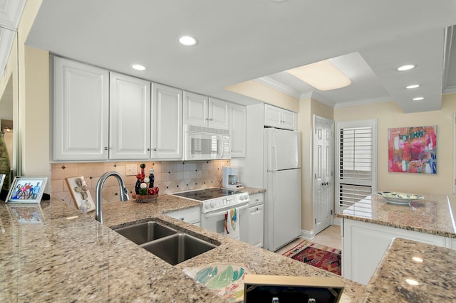 kitchen featuring sink, white appliances, crown molding, white cabinetry, and light stone countertops