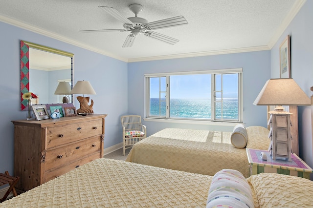 bedroom featuring a water view, ceiling fan, ornamental molding, and a textured ceiling