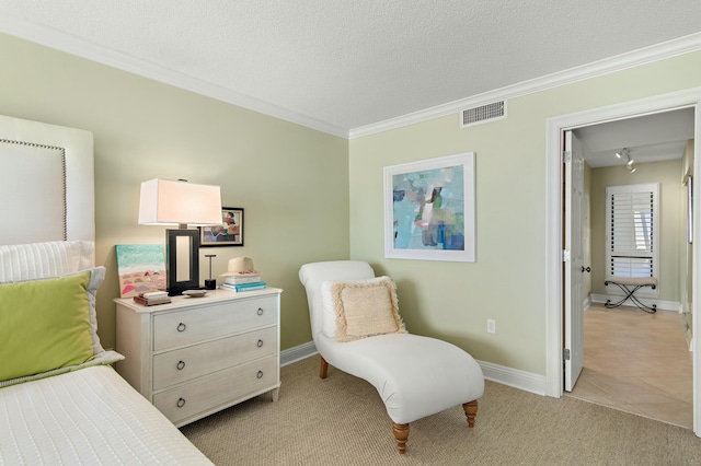 bedroom with ornamental molding, light carpet, and a textured ceiling