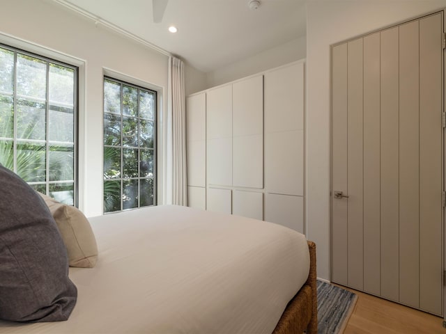 bedroom featuring ceiling fan and light hardwood / wood-style flooring