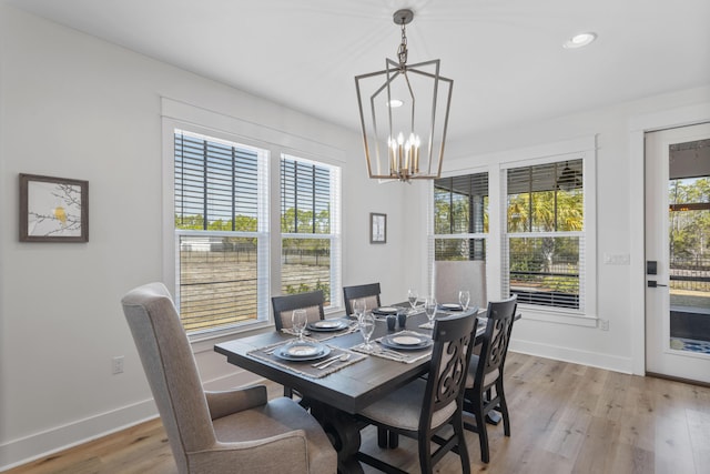 dining space with a chandelier and light hardwood / wood-style flooring