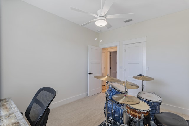 office with ceiling fan and light carpet