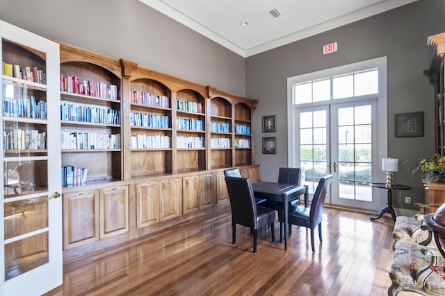 dining area featuring dark hardwood / wood-style flooring, crown molding, and french doors