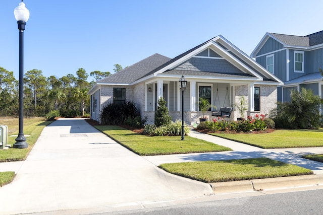 view of front facade with a front yard and a porch