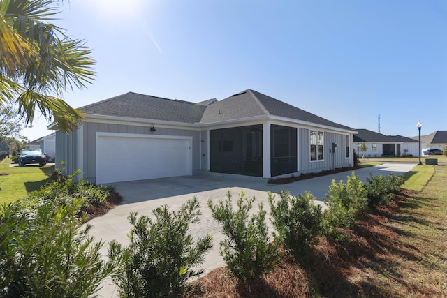 ranch-style house featuring a garage and a sunroom