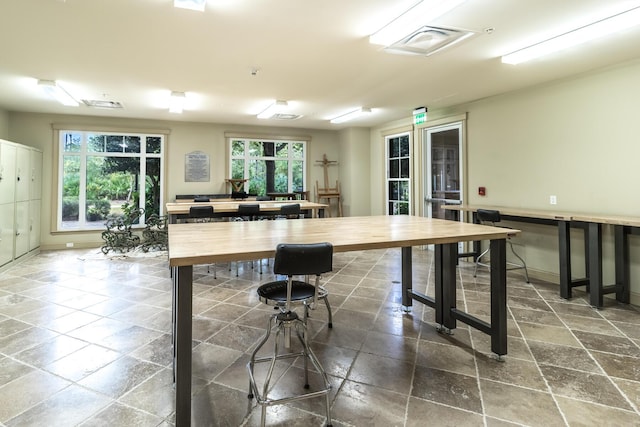 kitchen featuring plenty of natural light and butcher block counters