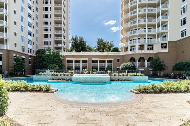 view of swimming pool with pool water feature