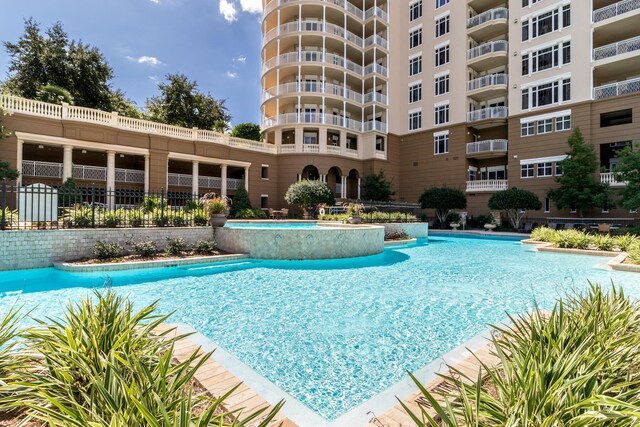 view of swimming pool featuring pool water feature