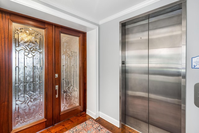 foyer featuring ornamental molding, dark hardwood / wood-style floors, and elevator