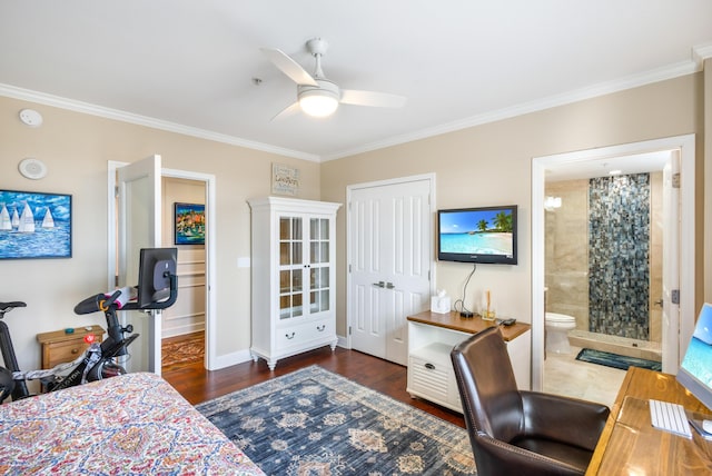 bedroom featuring ornamental molding, connected bathroom, dark hardwood / wood-style flooring, and a closet