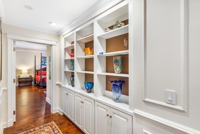 corridor featuring dark hardwood / wood-style flooring and crown molding