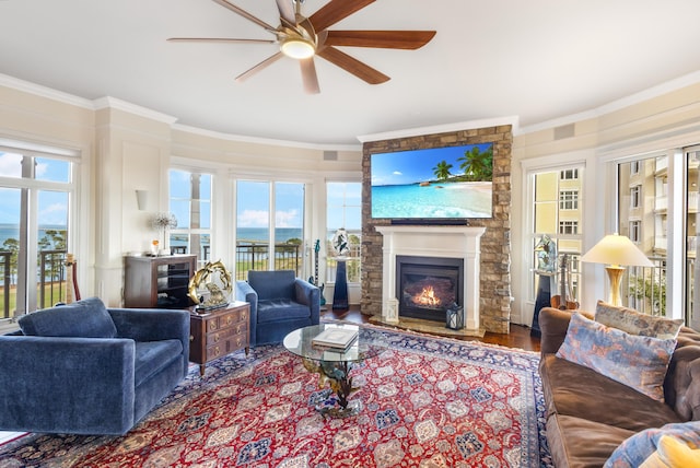 living room featuring hardwood / wood-style floors, crown molding, and ceiling fan