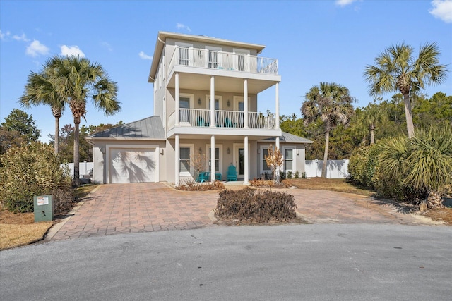 raised beach house with a balcony and a garage