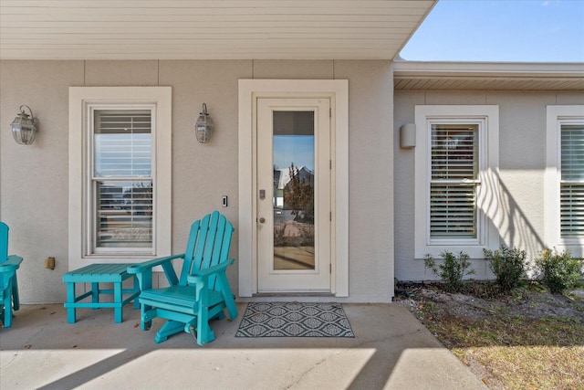 property entrance featuring a patio