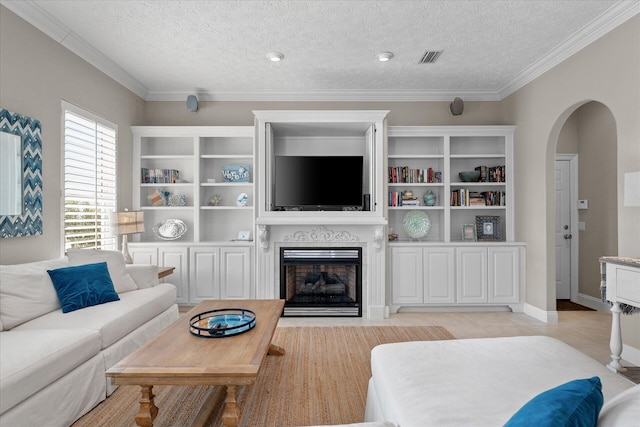 living room with ornamental molding and a textured ceiling