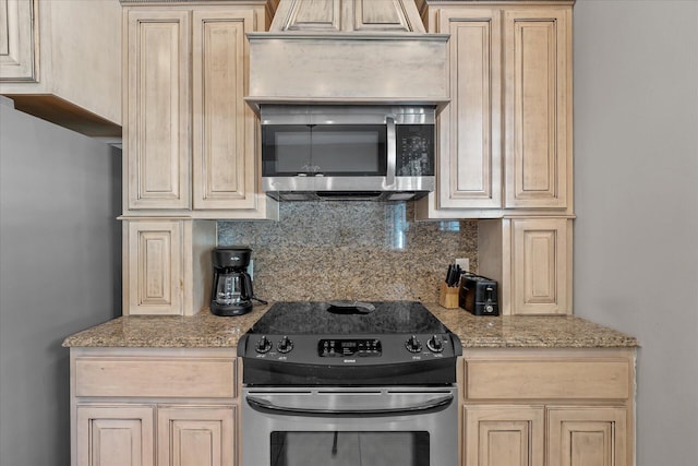 kitchen with light stone countertops, appliances with stainless steel finishes, light brown cabinets, and decorative backsplash