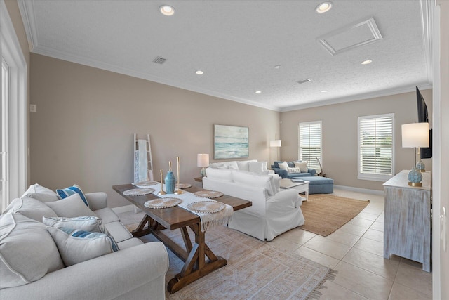 living room with light tile patterned floors, ornamental molding, and a textured ceiling