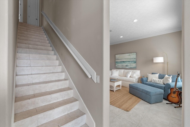 stairs featuring crown molding, tile patterned floors, and a textured ceiling