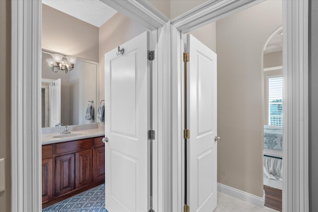 bathroom featuring vanity and a notable chandelier