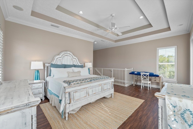 bedroom featuring crown molding, ceiling fan, dark hardwood / wood-style floors, and a raised ceiling