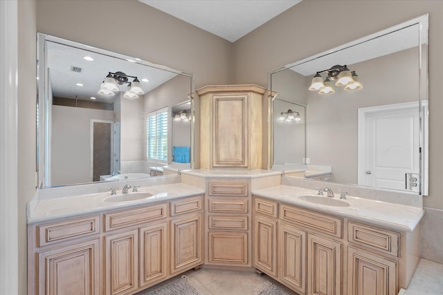 bathroom with vanity, a bathtub, and tile patterned floors