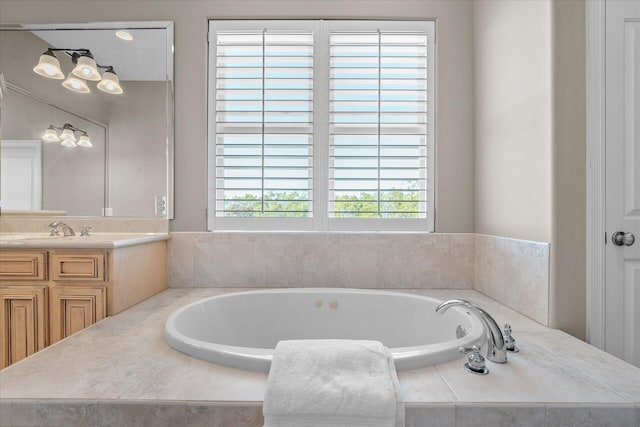 bathroom with vanity and tiled tub