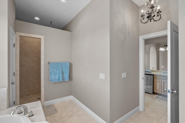 bathroom with vanity, tile patterned floors, independent shower and bath, and a textured ceiling