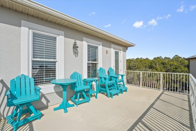 view of patio featuring a balcony