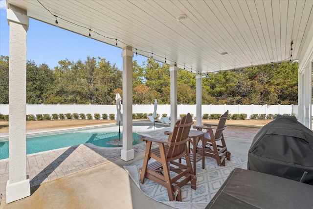 view of patio / terrace with a grill and a fenced in pool