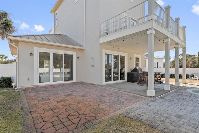 back of house featuring a balcony and a patio