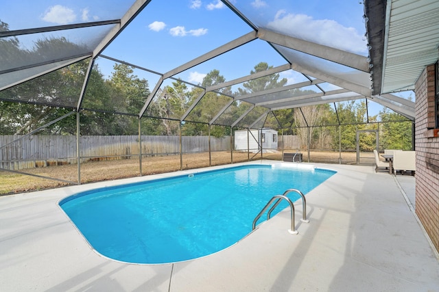 view of swimming pool featuring a lanai, a patio area, and a storage unit