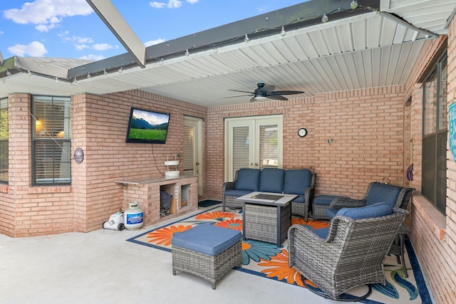 view of patio with ceiling fan and an outdoor living space with a fireplace