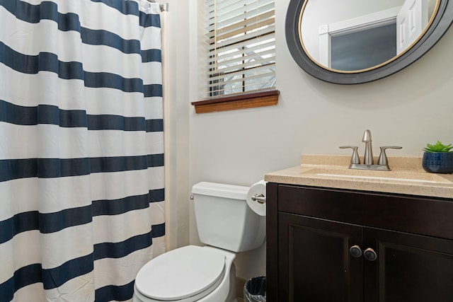 bathroom featuring vanity, toilet, and curtained shower