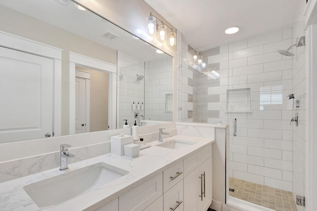 bathroom featuring vanity and a shower with door