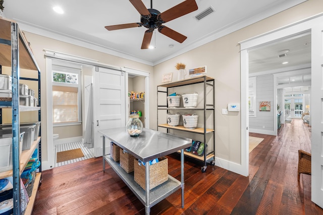 office with crown molding, visible vents, hardwood / wood-style floors, a barn door, and baseboards