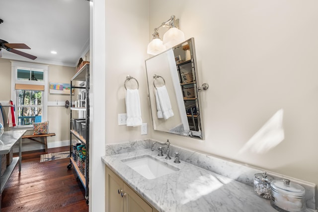 bathroom with recessed lighting, a ceiling fan, vanity, wood finished floors, and baseboards