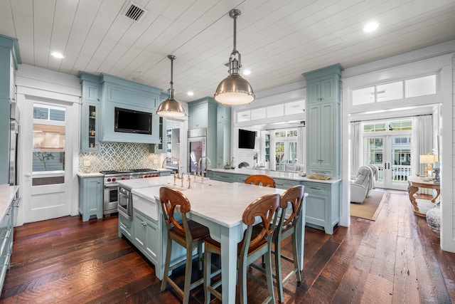 kitchen featuring french doors, high end appliances, visible vents, backsplash, and dark wood-type flooring