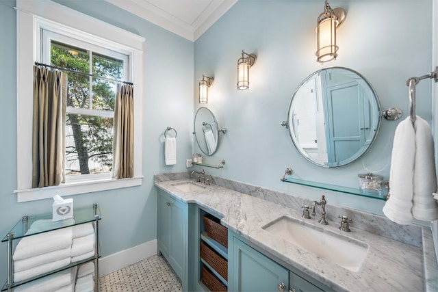 full bathroom featuring baseboards, double vanity, a sink, and crown molding