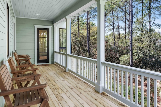 unfurnished sunroom featuring wooden ceiling and ornate columns