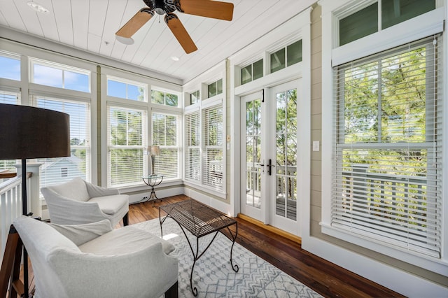 sunroom with wood ceiling, a ceiling fan, and a wealth of natural light