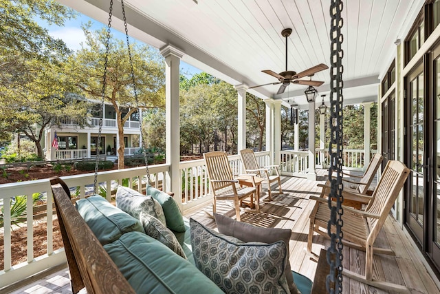 sunroom / solarium with a ceiling fan, wood ceiling, and ornate columns