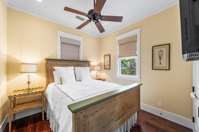 bedroom with ceiling fan, visible vents, baseboards, dark wood-style floors, and crown molding