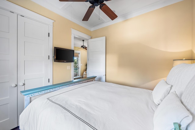 bedroom with attic access and a ceiling fan