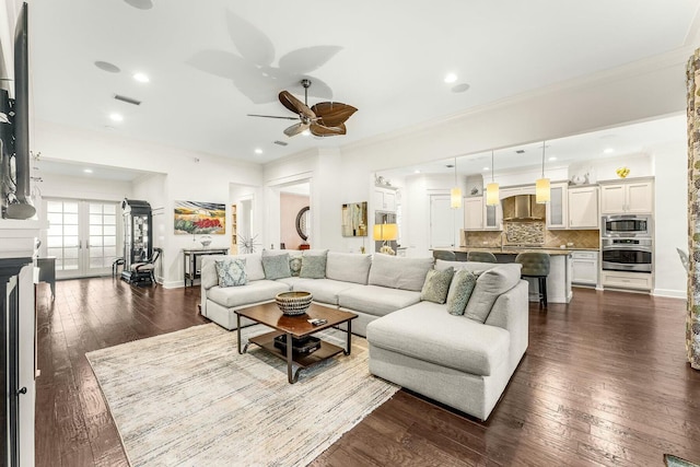 living room with recessed lighting, dark wood-style floors, baseboards, and ornamental molding