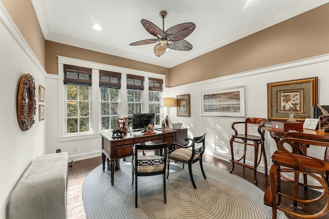 office space featuring baseboards, a ceiling fan, wood finished floors, and crown molding