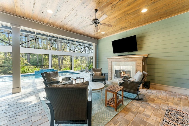 view of patio featuring glass enclosure, an outdoor living space with a fireplace, an outdoor pool, and ceiling fan