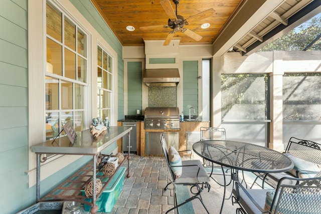 view of patio with grilling area, ceiling fan, outdoor dining space, area for grilling, and a sink